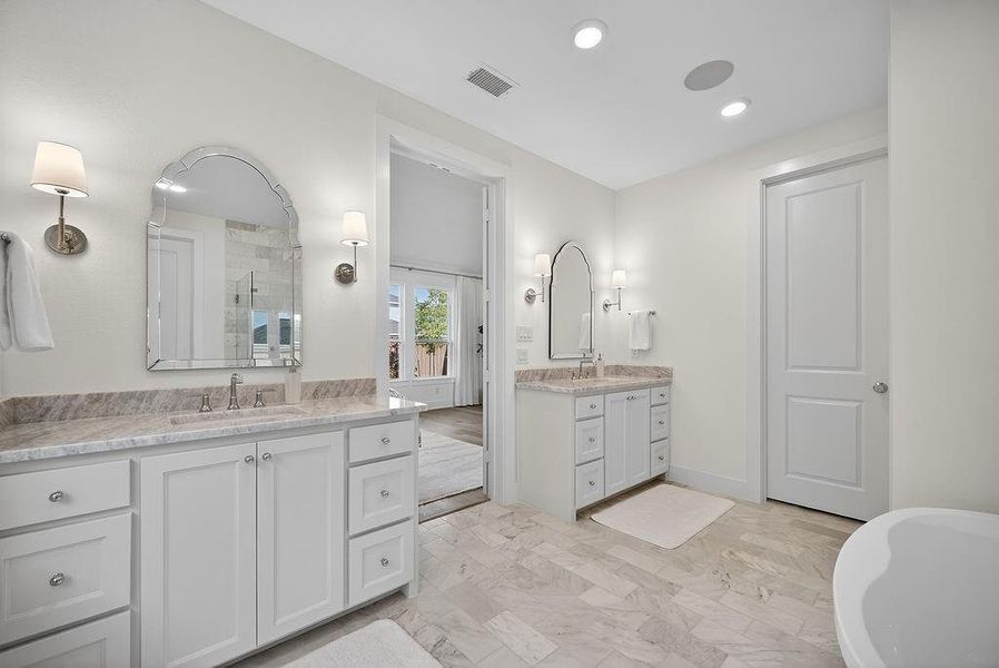 Full bathroom featuring a shower stall, two vanities, a soaking tub, and recessed lighting Full bathroom featuring a shower stall, two vanities, a soaking tub, and recessed lighting