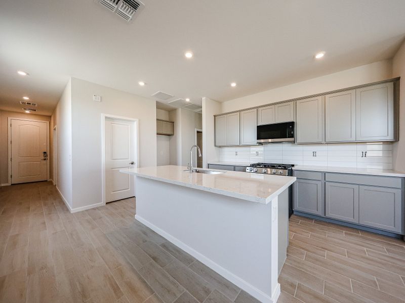 A kitchen with white cabinets.