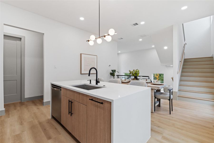 Modern minimalism meets effortless functionality—this oversized island anchors the open-concept layout with clean quartz surfaces, matte black fixtures, and built-in storage. Whether you’re prepping dinner or hosting friends, it’s the everyday centerpiece that does it all with style.