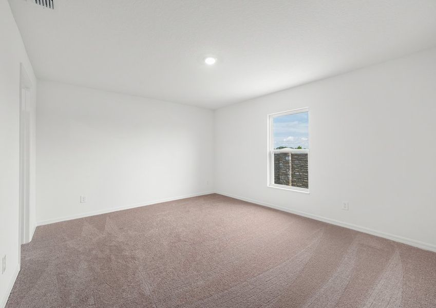 Large master bedroom with lush carpet