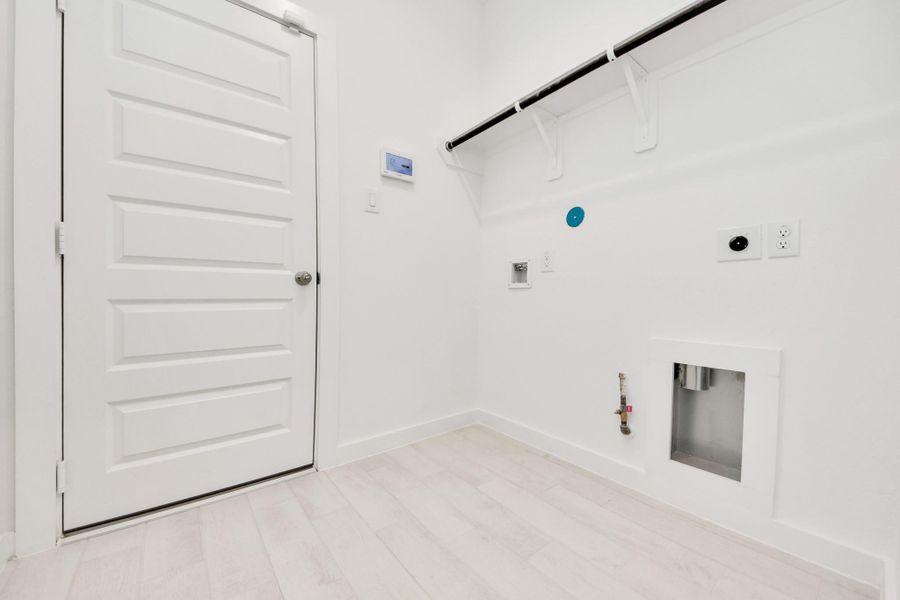 A perfect blend of functionality and comfort. Capture the essence of easy living with a first-floor laundry room, thoughtfully equipped with shelving for effortless organization. Both electric and gas connections available. A perfect blend of functionality and comfort. Capture the essence of easy living with a first-floor laundry room, thoughtfully equipped with shelving for effortless organization. Both electric and gas connections available.