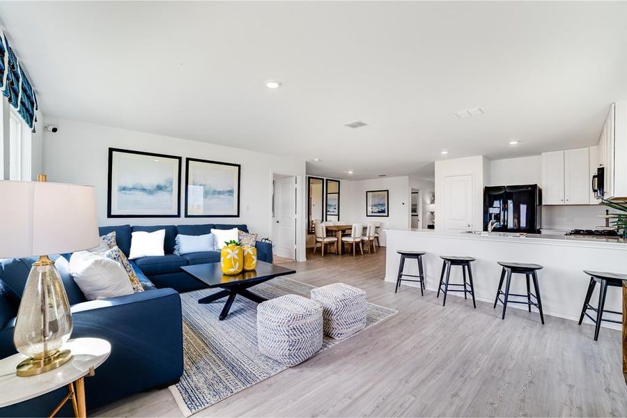 Living room featuring light wood-style flooring and recessed lighting Living room featuring light wood-style flooring and recessed lighting