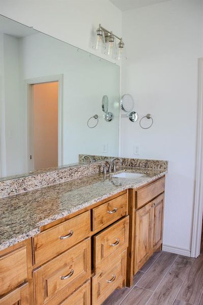 Bathroom featuring vanity and wood finished floors Bathroom featuring vanity and wood finished floors