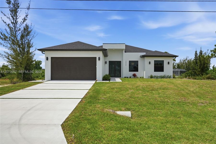 Front exterior of a new home in , Cape Coral, FL, highlighting curb appeal (Image 19). Front exterior of a new home in , Cape Coral, FL, highlighting curb appeal (Image 19).