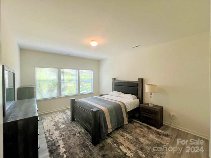 Primary Bedroom with lots of natural light and view to private backyard.