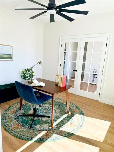 Office space with hardwood / wood-style floors, french doors, and ceiling fan