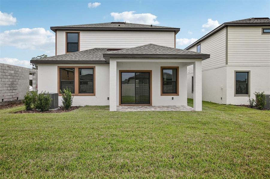 Exterior details and patio area of a home in Grasslands West, Lakeland (Image 27).