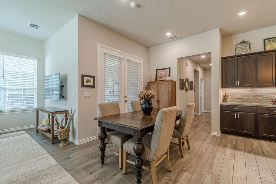 Dining space with light wood-style flooring, baseboards, and recessed lighting