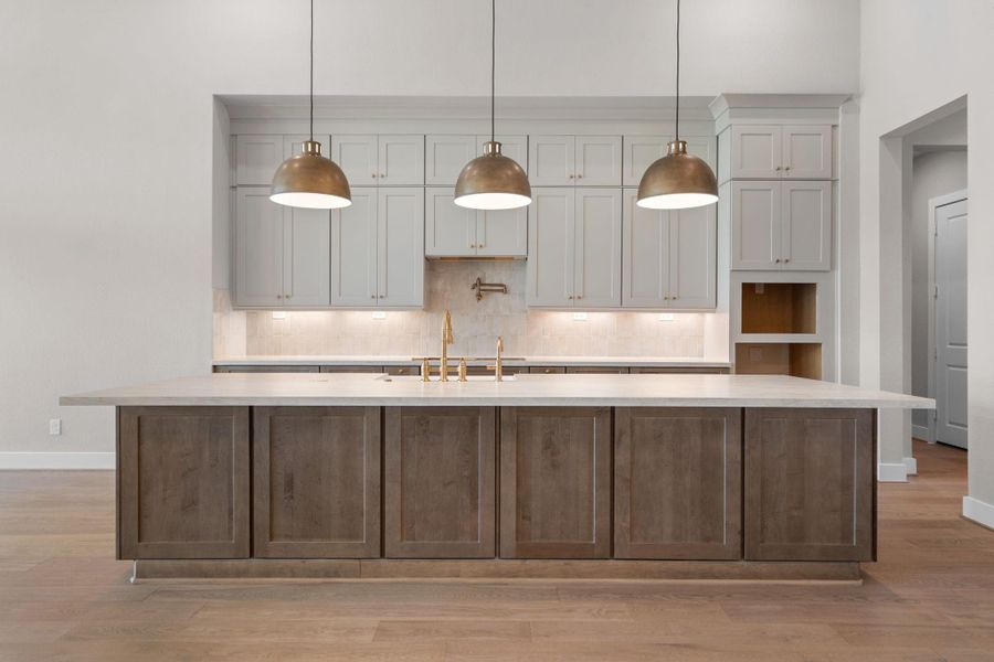 A massive island anchors the generous kitchen, ready for multiple cooks