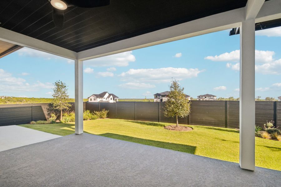 Exterior details and patio area of a home in Milky Way at River Place, Austin (Image 26).