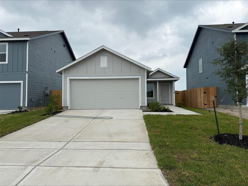 Front exterior of a new home in Avalon Ridge: Cottage, Conroe, TX, highlighting curb appeal (Image 2). Front exterior of a new home in Avalon Ridge: Cottage, Conroe, TX, highlighting curb appeal (Image 2).