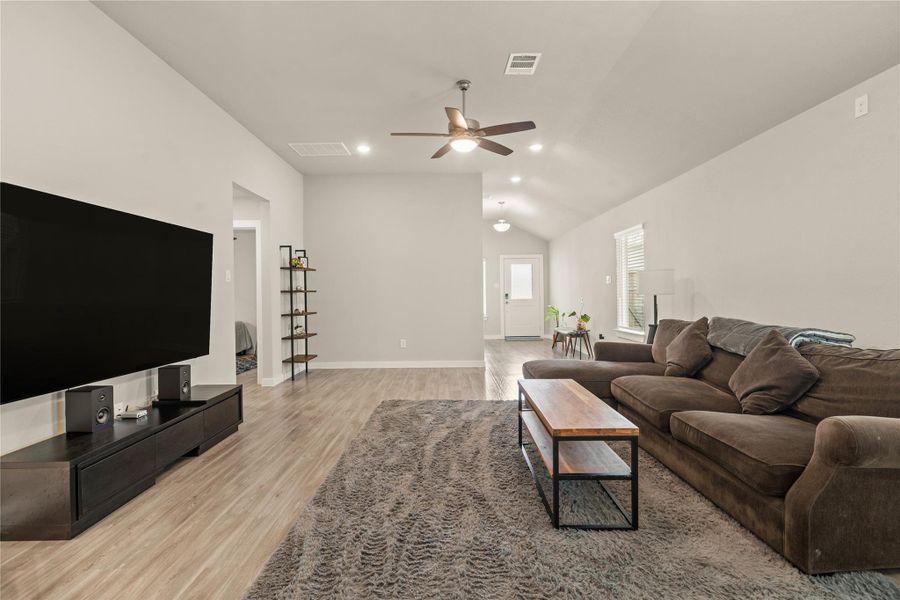 Large windows provide abundant natural light, while the generous wall space is ideal for a media setup or custom décor. The neutral color palette and modern finishes create a warm, contemporary atmosphere throughout.