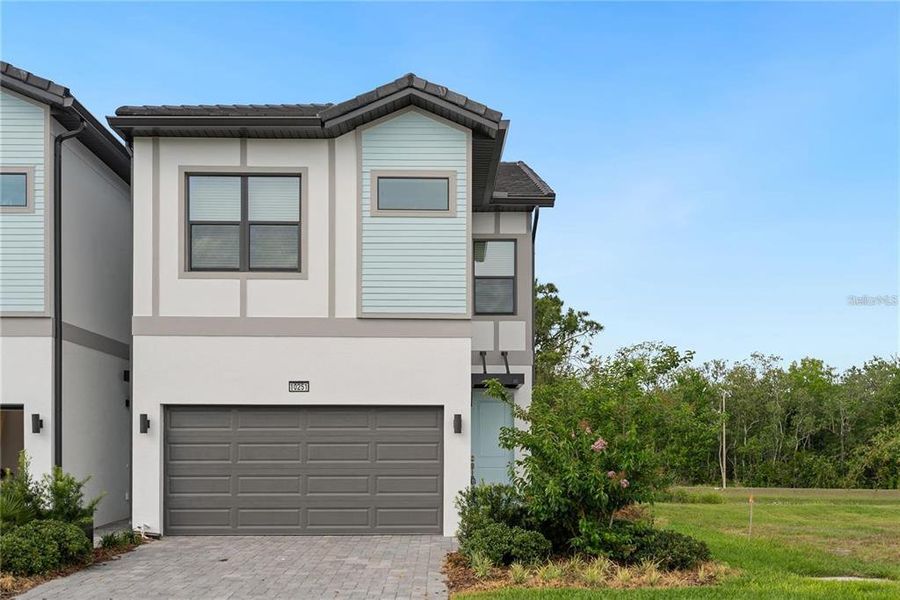 Front exterior of a new home in , Orlando, FL, highlighting curb appeal (Image 21).