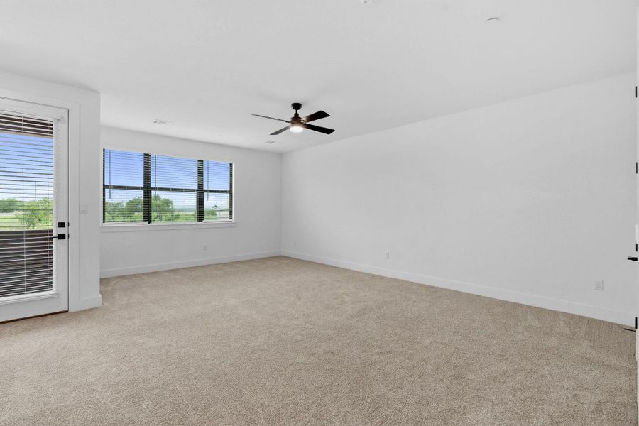 Private retreat featuring direct access to a covered outdoor space and expansive windows for natural light.