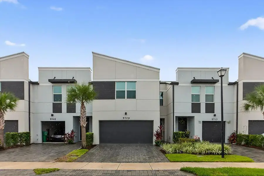 Front exterior of a new home in Enclave at Mangonia Park, West Palm Beach, FL, highlighting curb appeal (Image 2).
