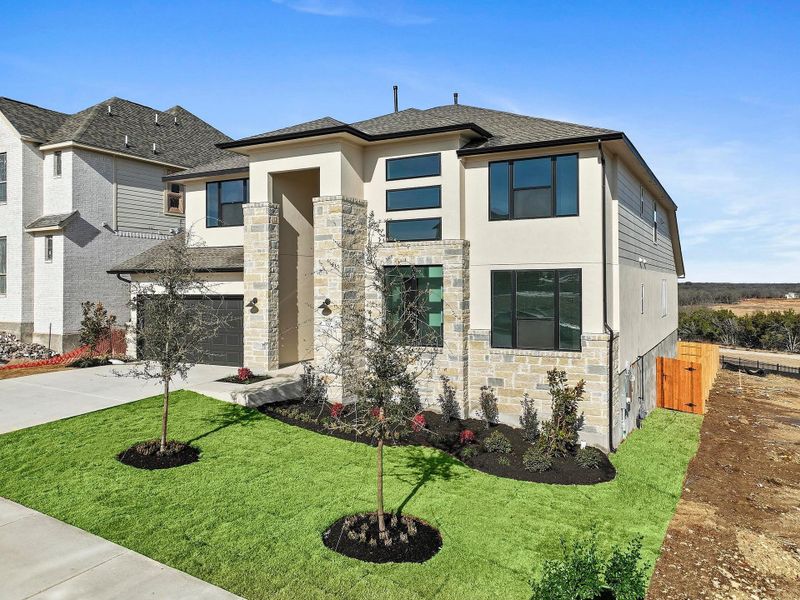 Front exterior of a new home in Lariat, Liberty Hill, TX, highlighting curb appeal (Image 23).