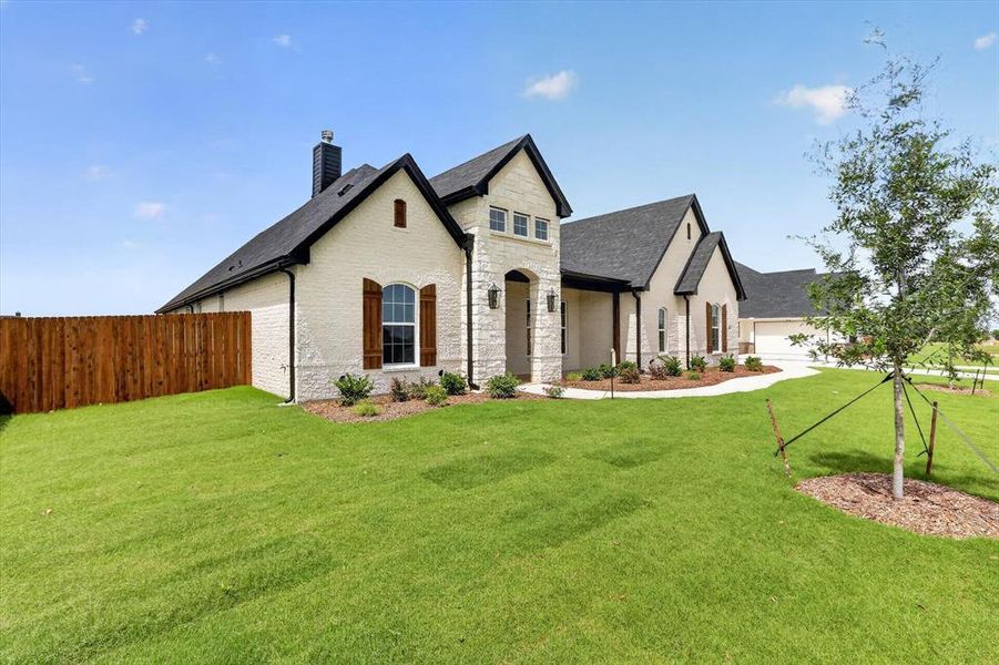 Front exterior of a new home in Coyote Crossing, Godley, TX, highlighting curb appeal (Image 22). Front exterior of a new home in Coyote Crossing, Godley, TX, highlighting curb appeal (Image 22).