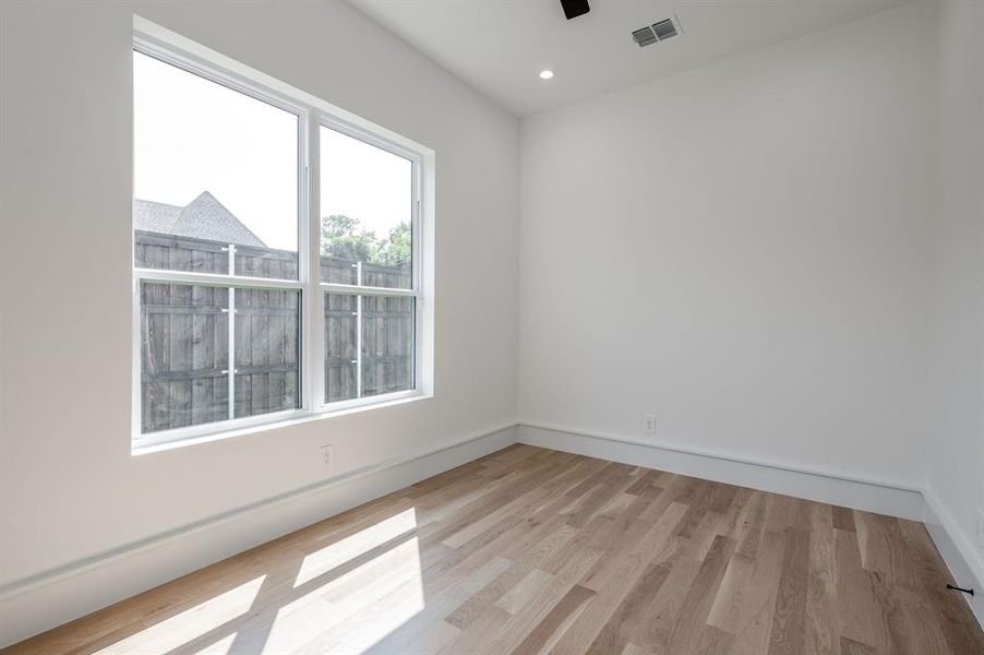Empty room with light wood finished floors and recessed lighting Empty room with light wood finished floors and recessed lighting