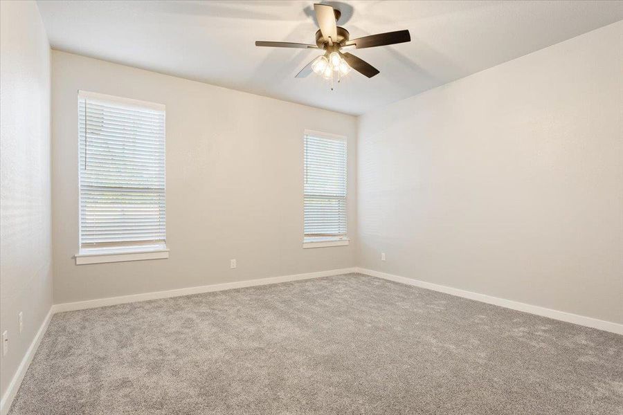 Spare room featuring carpet flooring and ceiling fan Spare room featuring carpet flooring and ceiling fan