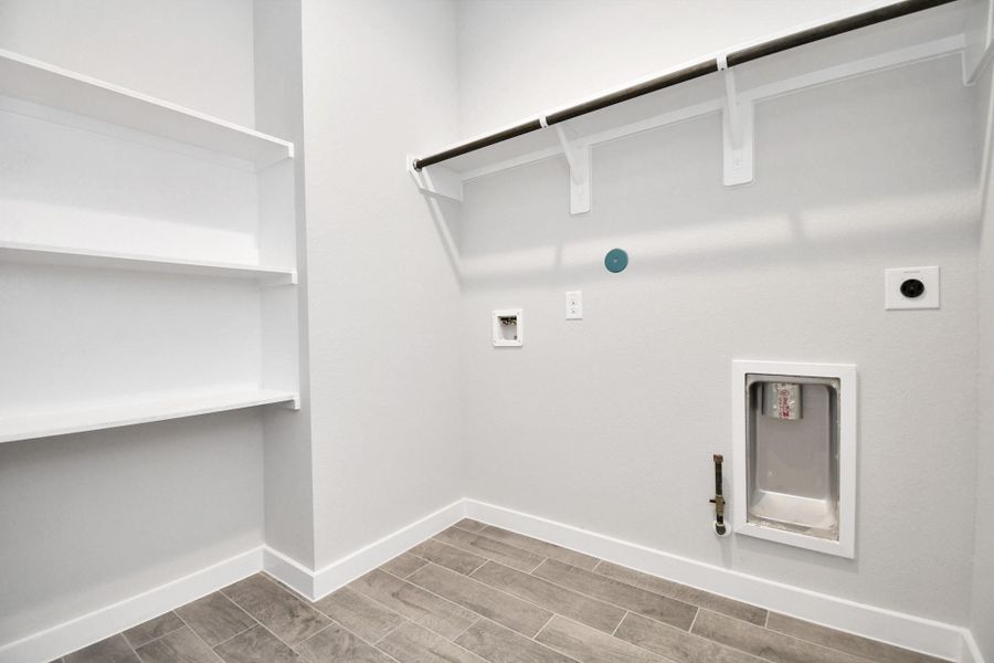 A perfect blend of functionality and comfort. Capture the essence of easy living with a first-floor laundry room, thoughtfully equipped with shelving for effortless organization. Both electric and gas connections available. A perfect blend of functionality and comfort. Capture the essence of easy living with a first-floor laundry room, thoughtfully equipped with shelving for effortless organization. Both electric and gas connections available.