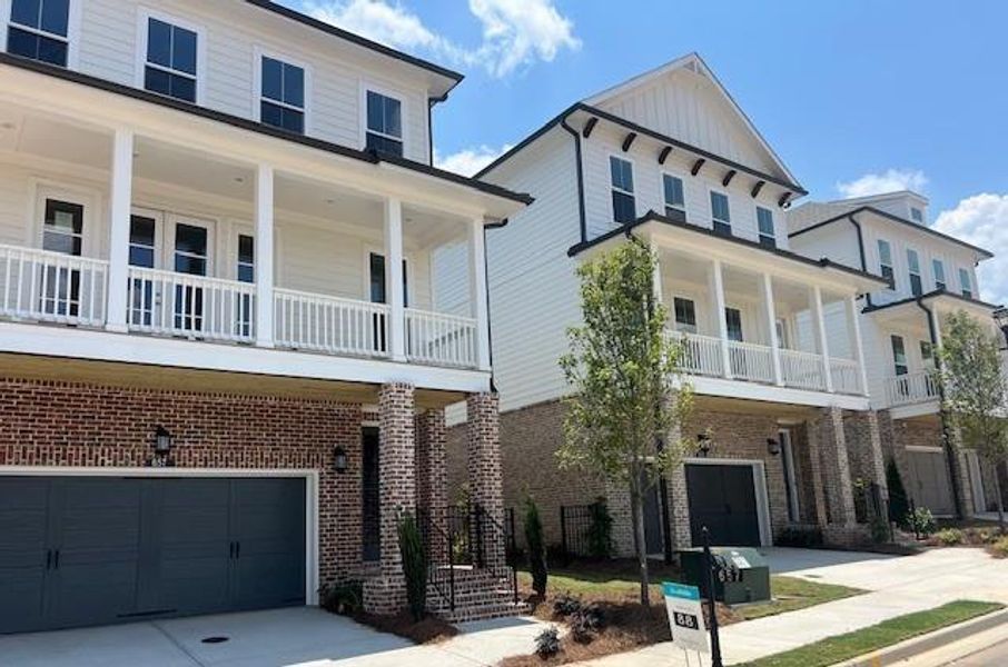 Front exterior of a new home in Palisades Single Family, Cumming, GA, highlighting curb appeal (Image 20).