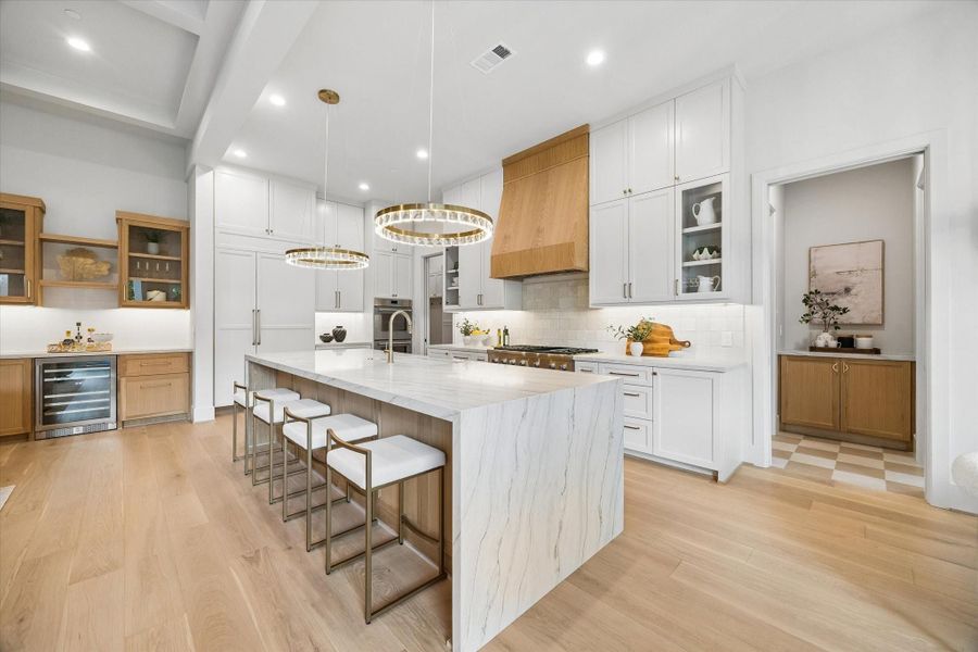 A closer look at the kitchen island showcases the natural stone surface, custom cabinetry, and generous prep space at the center of the home. A closer look at the kitchen island showcases the natural stone surface, custom cabinetry, and generous prep space at the center of the home.