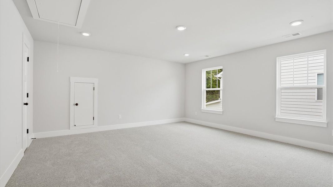 Top-notch design defines this bonus room with carpeted floors and an open, airy layout located at Creeks at Midway