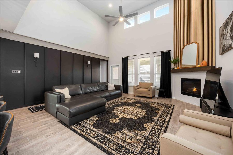 Alternate view of the living room showcasing the fireplace, windows, and spacious seating area. Alternate view of the living room showcasing the fireplace, windows, and spacious seating area.