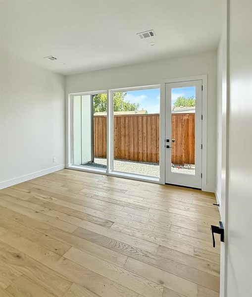 Unfurnished room with light wood finished floors and recessed lighting Unfurnished room with light wood finished floors and recessed lighting