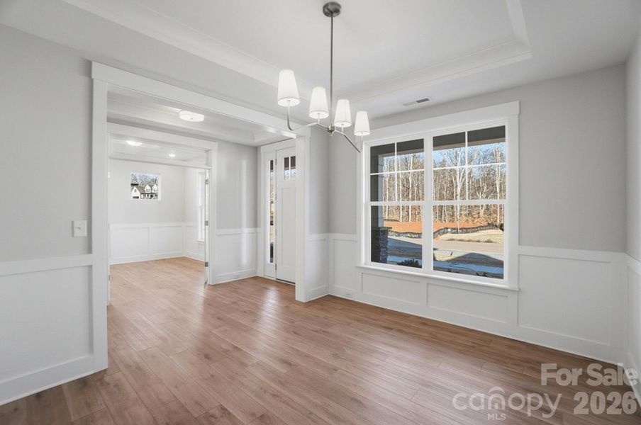 Dining room with Craftsman-style trim and tray ceiling