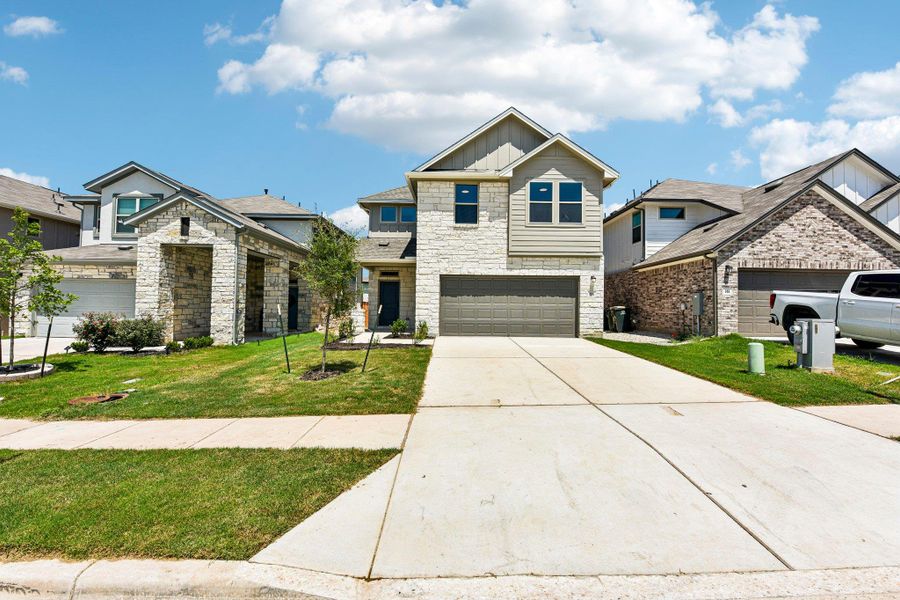 Front exterior of a new home in Crosswinds, Kyle, TX, highlighting curb appeal (Image 2).
