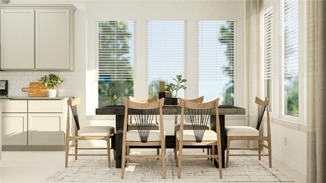 Dining area with light wood-style flooring Dining area with light wood-style flooring