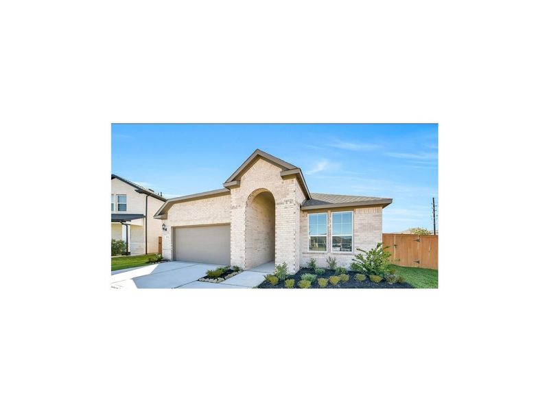 Front exterior of a new home in Sunterra, Katy, TX, highlighting curb appeal (Image 1).