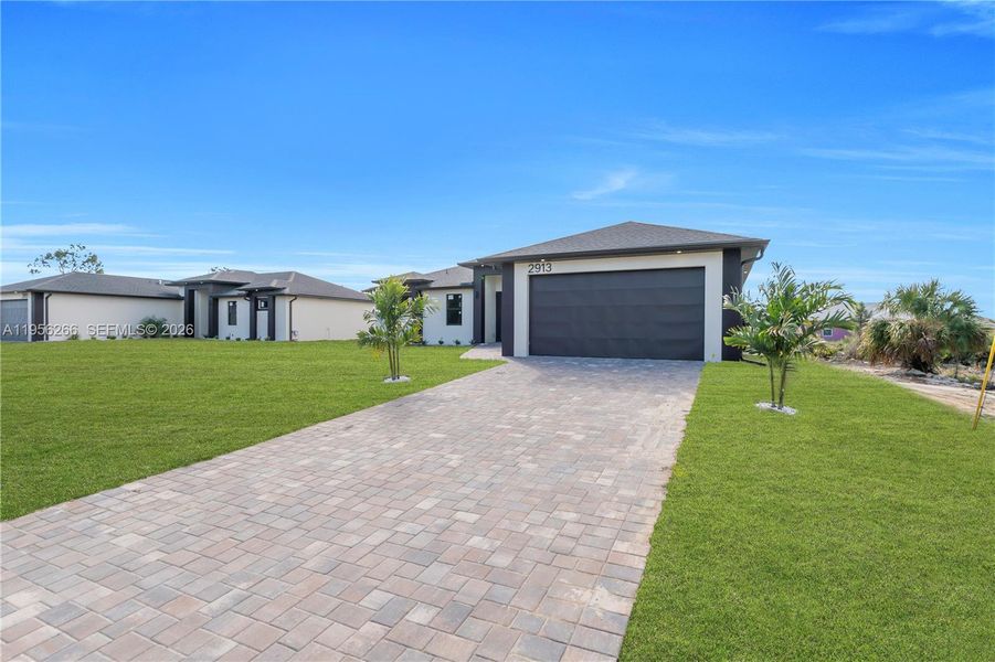 Front exterior of a new home in , Lehigh Acres, FL, highlighting curb appeal (Image 29).