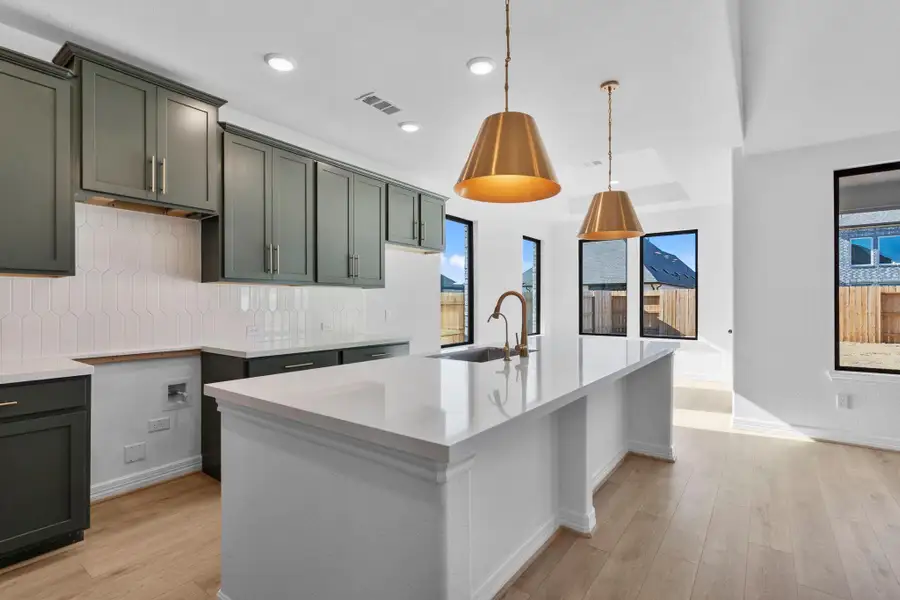 The kitchen is a true showpiece, blending statement surfaces with timeless, neutral elegance.