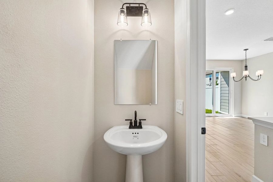 Half bathroom located off the kitchen on the first floor