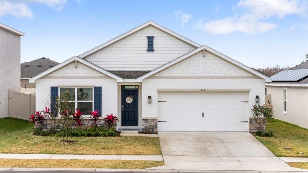 Front exterior of a new home in Farm at Varrea, Plant City, FL, highlighting curb appeal (Image 1). Front exterior of a new home in Farm at Varrea, Plant City, FL, highlighting curb appeal (Image 1).