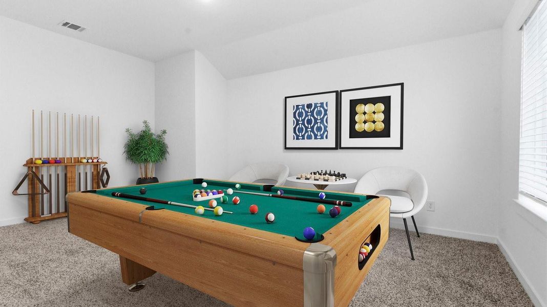 A spacious upstairs game room with plenty of natural light from windows overlooking side of the home A spacious upstairs game room with plenty of natural light from windows overlooking side of the home