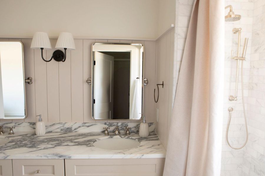 Full bathroom featuring double vanity and a tile shower Full bathroom featuring double vanity and a tile shower