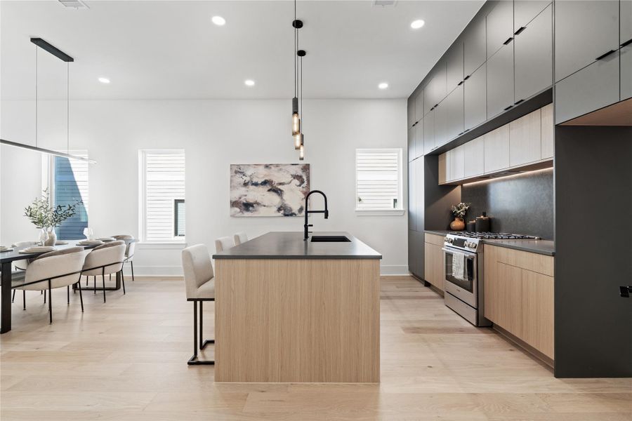 Rooted in Scandinavian minimalism and elevated by tailored execution, the kitchen at 1030 W 24th is both striking and deeply functional. Two-tone European flat-front cabinetry in matte black and warm wood offers sculptural contrast, while a waterfall island anchors the space in quiet luxury. Outfitted with Bosch appliances and a matte black faucet, this culinary core is as much about performance as it is about presence—inviting everything from casual breakfasts to curated dinner parties. Rooted in Scandinavian minimalism and elevated by tailored execution, the kitchen at 1030 W 24th is both striking and deeply functional. Two-tone European flat-front cabinetry in matte black and warm wood offers sculptural contrast, while a waterfall island anchors the space in quiet luxury. Outfitted with Bosch appliances and a matte black faucet, this culinary core is as much about performance as it is about presence—inviting everything from casual breakfasts to curated dinner parties.