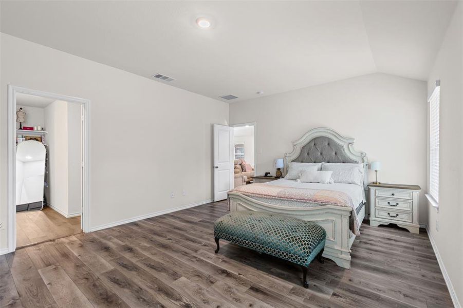 Expansive primary suite with oversized windows, natural light, and luxury vinyl plank flooring. Expansive primary suite with oversized windows, natural light, and luxury vinyl plank flooring.