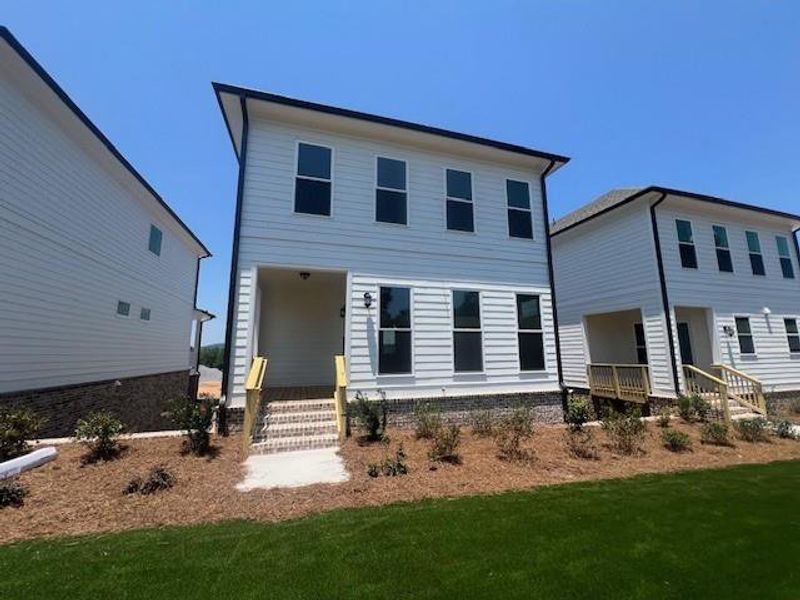 Front exterior of a new home in Palisades Single Family, Cumming, GA, highlighting curb appeal (Image 26).