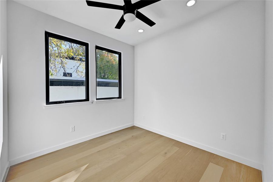 Unfurnished room with light wood-style flooring, ceiling fan, and recessed lighting