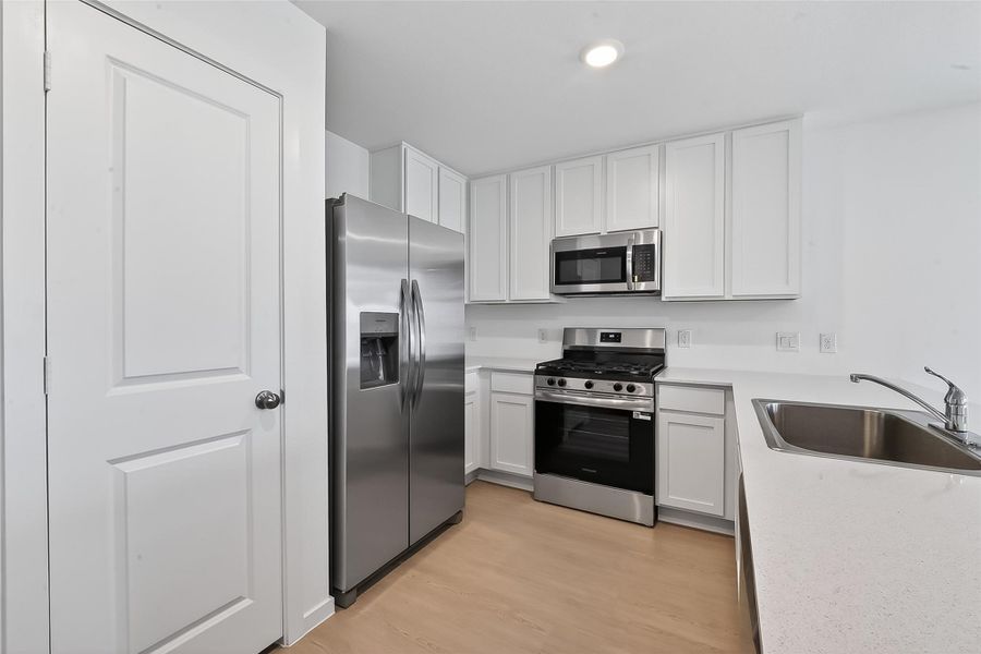 Stainless steel appliances and an ample pantry will make cooking a joy!