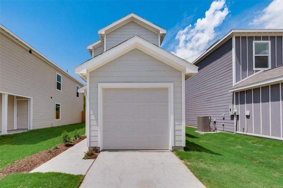 Garage with cooling unit and a lawn