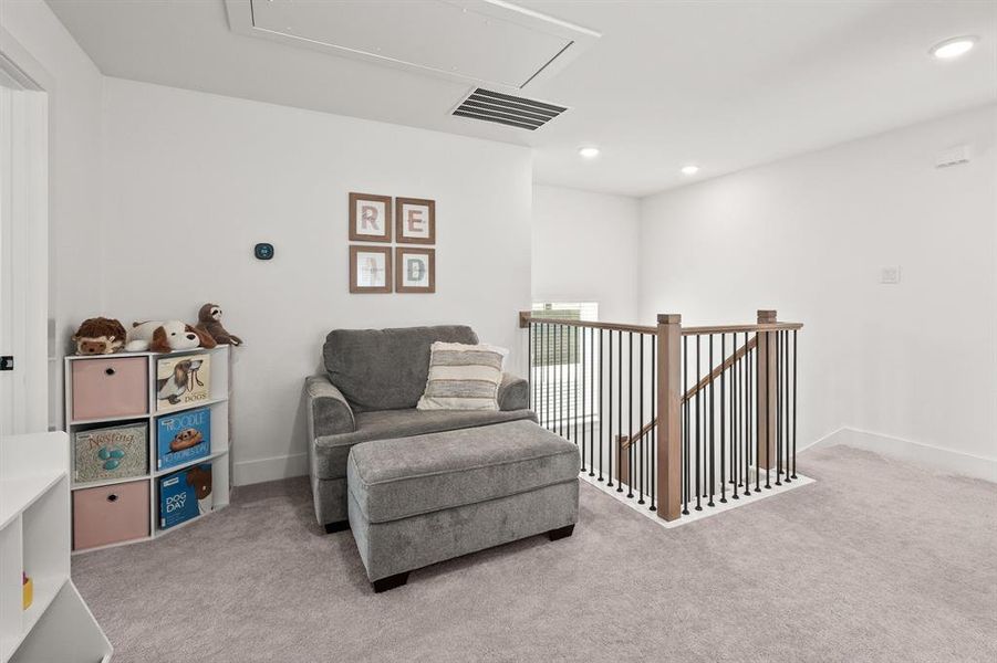 Living area featuring attic access, an upstairs landing, light colored carpet, and recessed lighting Living area featuring attic access, an upstairs landing, light colored carpet, and recessed lighting