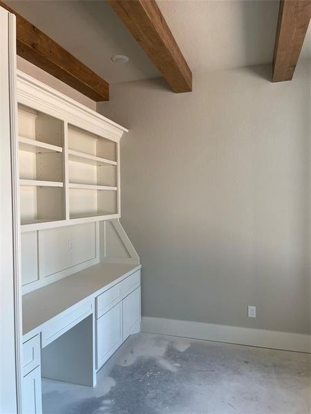 Custom built in and beams in study.