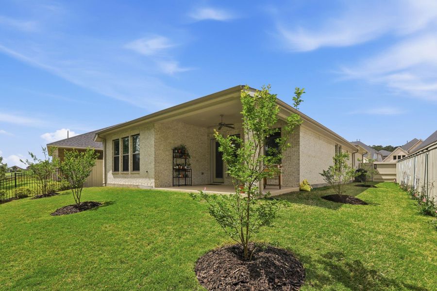 The private backyard offers a seamless extension of living space with no rear neighbors and lush tree views.