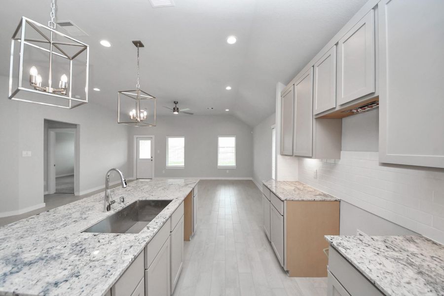 All of this overlooks your expansive family room, creating a perfect space for culinary delights and family gatherings.