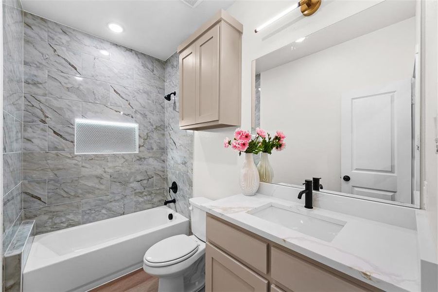 Contemporary bathroom featuring a white vanity with a rectangular undermount sink, quartz countertop, and matte black faucet Contemporary bathroom featuring a white vanity with a rectangular undermount sink, quartz countertop, and matte black faucet
